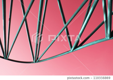 Abstract metal figure on a colorful background, artistically welded metal pipes Abstract metal figure on a colorful background, artistically welded metal pipes 110338869