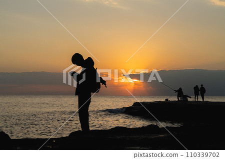 People enjoying their time while watching the sunset People enjoying their time while watching the sunset 110339702