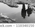 Two people reflected on the water surface 110340150