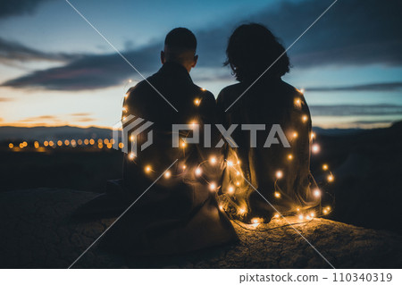 Couple looking the sunset Couple looking the sunset 110340319