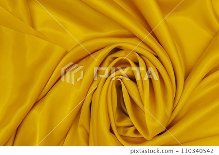 Mockup Abstract silk yellow background. Luxurious smooth elegant wavy fabric. Can be used for your design. Top View, Copy Space 110340542