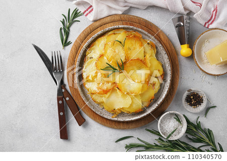 Potato gratin - graten (baked potatoes with cream and cheese) with rosemary served on the plate 110340570