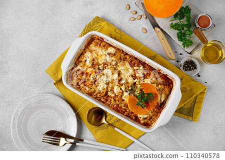 Italian food pumpkin lasagna with pumpkin instead of pasta leaves in the cooking dish. Italian food pumpkin lasagna with pumpkin instead of pasta leaves in the cooking dish. 110340578