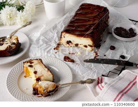 Lviv cheesecake, a traditional Ukrainian dessert with raisins, coated with chocolate icing Lviv cheesecake, a traditional Ukrainian dessert with raisins, coated with chocolate icing 110340600