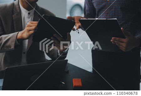 Audit concept,Administrator business man financial inspector and secretary making report calculating balance. Internal Revenue Service checking document. 110340678