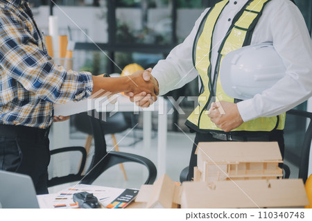 Construction and structure concept of Engineer or architect meeting for project working with partner and engineering tools on model building and blueprint in working site, contract for both companies. Construction and structure concept of Engineer or architect meeting for project working with partner and engineering tools on model building and blueprint in working site, contract for both companies. 110340748