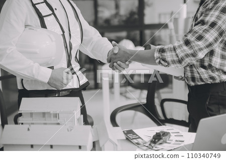 Construction and structure concept of Engineer or architect meeting for project working with partner and engineering tools on model building and blueprint in working site, contract for both companies. 110340749