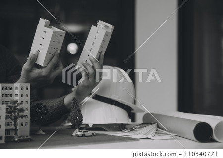 Construction and structure concept of Engineer or architect meeting for project working with partner and engineering tools on model building and blueprint in working site, contract for both companies. 110340771
