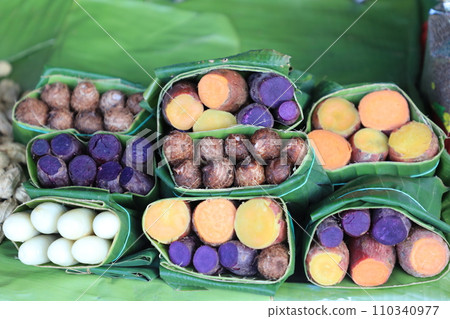 Group of waternut, chinese water chestnut, purple and yeloow sweet potato in banana leaf plate in the fresh market. Group of waternut, chinese water chestnut, purple and yeloow sweet potato in banana leaf plate in the fresh market. 110340977