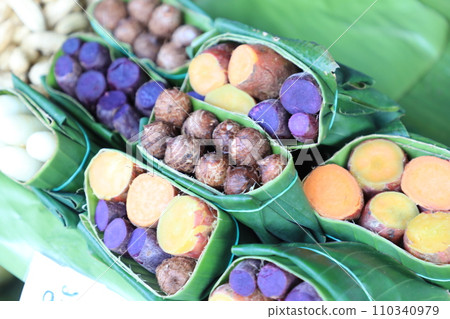 Group of waternut, chinese water chestnut, purple and yeloow sweet potato in banana leaf plate in the fresh market. Group of waternut, chinese water chestnut, purple and yeloow sweet potato in banana leaf plate in the fresh market. 110340979