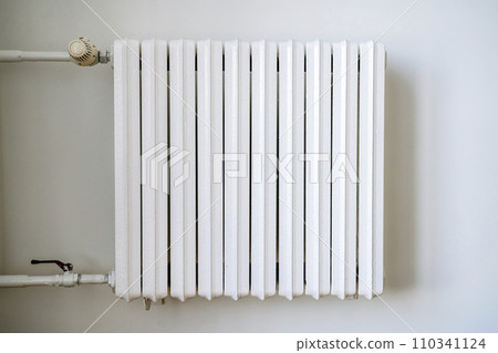 Heating radiator in the interior of an apartment or house during the cold winter heating period 110341124