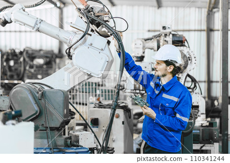 Engineer worker fix service replace broken part of automatic industry robotic welding arm. technician staff repair maintenance robot welding machine. 110341244