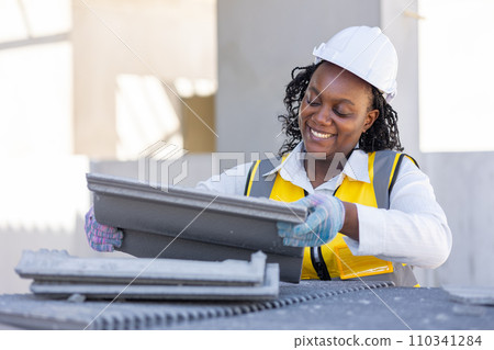 Happy black african working women worker enjoy hard work for smart healthy and good welfare labor care and safety in construction site. Happy black african working women worker enjoy hard work for smart healthy and good welfare labor care and safety in construction site. 110341284