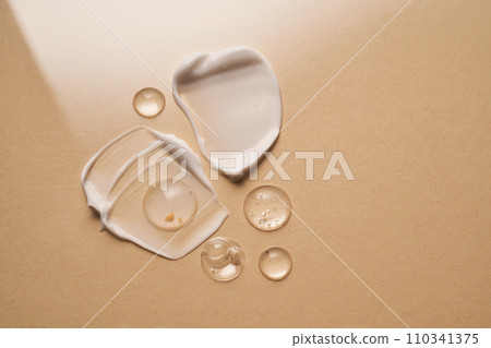 Gel, serum and a cream on a a beige background. 110341375
