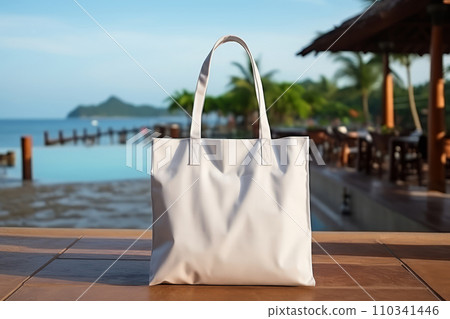 AI-generated content. Blank Eco Cotton Tote Bag on Summer Resort Background. White Shopper Mock-up For Displaying Art Design of Brand or Logo 110341446