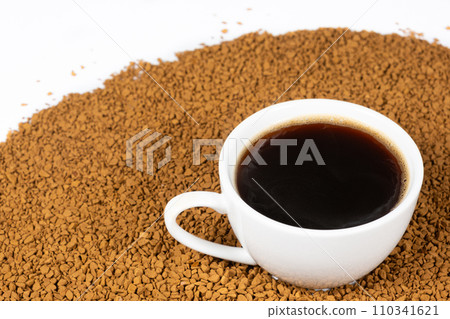 A cup of hot instant coffee on a background of freeze-dried granules 110341621