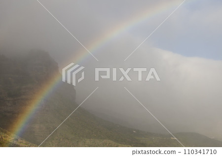 Rainbow and Tirajana cliffs in the fog. Rainbow and Tirajana cliffs in the fog. 110341710