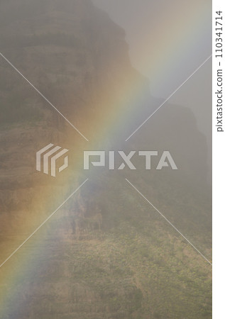 Rainbow and Tirajana cliffs in the fog. Rainbow and Tirajana cliffs in the fog. 110341714
