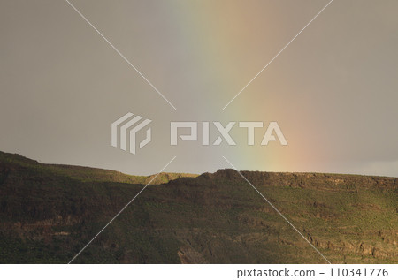 Rainbow over a ridge of the Tirajana crater. Rainbow over a ridge of the Tirajana crater. 110341776