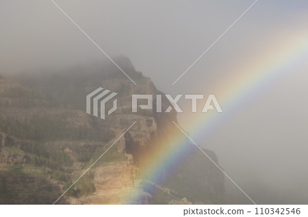 Rainbow and Tirajana cliffs in the fog. Rainbow and Tirajana cliffs in the fog. 110342546