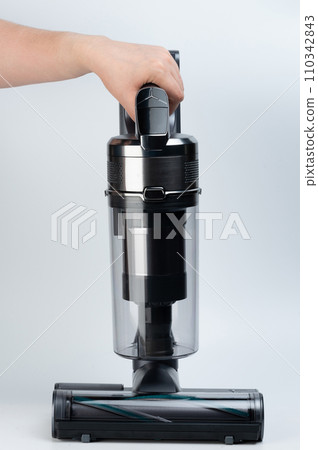 Close up of gray vacuum cleaner in hand Close up of gray vacuum cleaner in hand 110342843