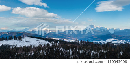 Winter cloudy day snow covered alp mountain ridge (Ukraine, Carpathian Mountains, Chornohora Range - Hoverla, Petros and other mountains, scenery view from Yablunytsia pass). 110343008