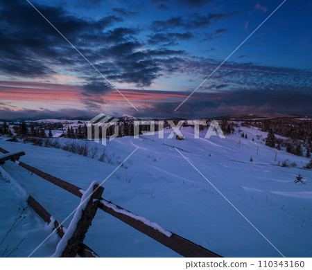 Night countryside hills, groves and farmlands in winter remote alpine mountain village. Ukraine, Voronenko. 110343160