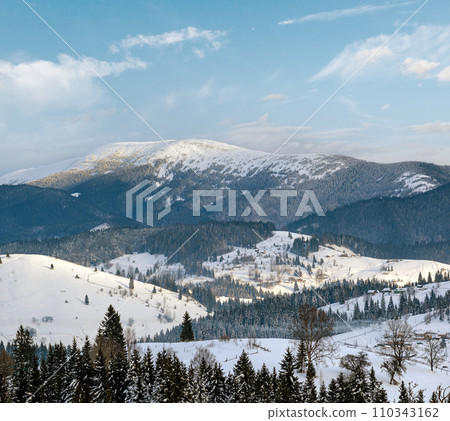 Small alpine village and winter snowy mountains in first sunrise sunlight around, Voronenko, Carpathian, Ukraine. Small alpine village and winter snowy mountains in first sunrise sunlight around, Voronenko, Carpathian, Ukraine. 110343162