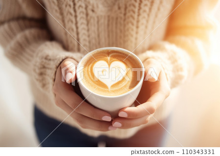 Woman's hands holds coffee cup with heart shape latte coffee art. Generative AI 110343331