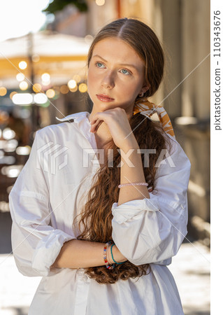 Sad unhappy frustrated child girl standing alone in city street, feeling bad annoyed, grief, problem 110343676