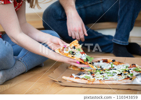 A couple in love met on a date and are eating pizza. A couple in love met on a date and are eating pizza. 110343859