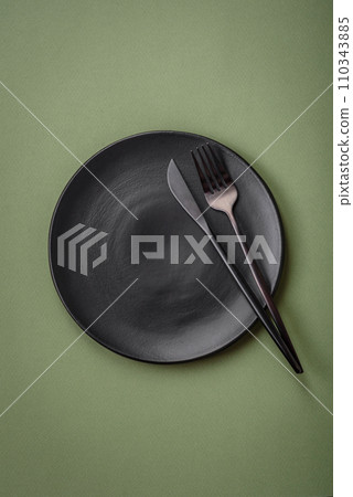 Empty round ceramic plate on a plain background, flatley with copy space 110343885