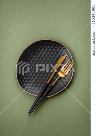 Empty round ceramic plate on a plain background, flatley with copy space 110343906