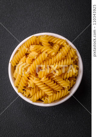 Raw fusilli pasta from whole grain wheat varieties Raw fusilli pasta from whole grain wheat varieties 110343925