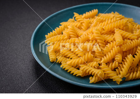 Raw fusilli pasta from whole grain wheat varieties Raw fusilli pasta from whole grain wheat varieties 110343929
