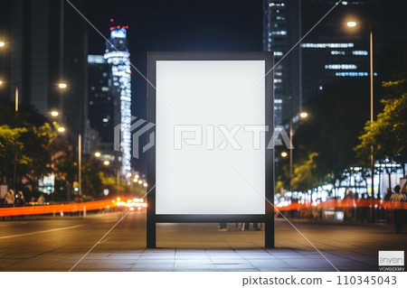 Blank white vertical digital billboard poster on city street bus stop sign at nigh 110345043