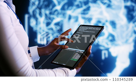 Professional updating AI systems, writing intricate binary code scripts on tablet, visualizing result wth AR. Worker using programming to upgrade artificial intelligence simulation model, close up Professional updating AI systems, writing intricate binary code scripts on tablet, visualizing result wth AR. Worker using programming to upgrade artificial intelligence simulation model, close up 110345289