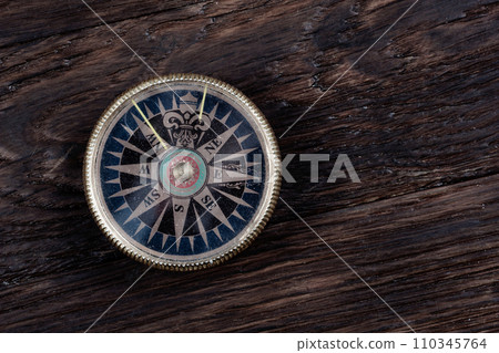 Vintage retro compass on wooden background 110345764