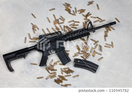 M4 carbine and 5.56mm shells and magazine with bullets M4 carbine and 5.56mm shells and magazine with bullets 110345782