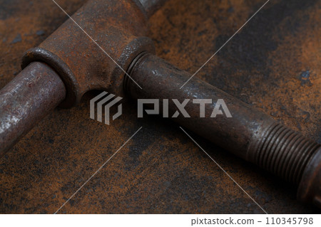 Rusty plumb tube on rusty metal wall 110345798