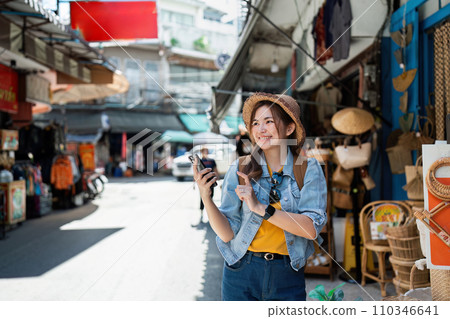 Young Asian woman backpack traveler using a mobile. Journey trip lifestyle. travel concept Young Asian woman backpack traveler using a mobile. Journey trip lifestyle. travel concept 110346641