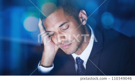 Tired, overworked and exhausted businessman sleeping while working overtime in the office at night. Fatigue, burnout and lazy corporate manager sitting at desk and taking nap in the company building. 110349046