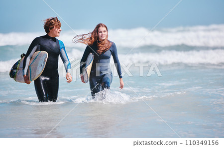 Surf, sea and love with a couple in the ocean water for surfing, fun and dating. Sport, dating and nature with a young man and woman with a surfboard on holiday or vacation outside in nature 110349156