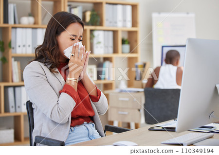 Sick, ill and sneezing business woman with cold, flu or allergy while working at office. Workaholic or manager trying to work at desk with covid disease virus or bad work life balance at workplace 110349194