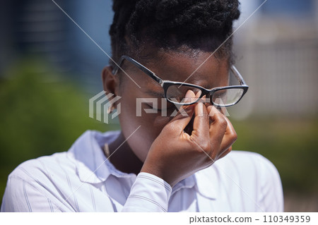 Headache, stress or mental health and a frustrated or sad black woman with depression outside. Anxiety, pain or anger and a female struggling with burnout, compliance or making a mistake outdoors 110349359