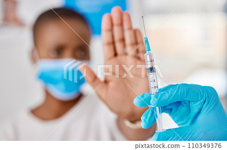 Vaccine hesitancy, covid and female patient stopping doctor from giving the injection at the clinic. Woman refusing to take the vaccination while a healthcare worker prepares the needle and syringe. 110349376