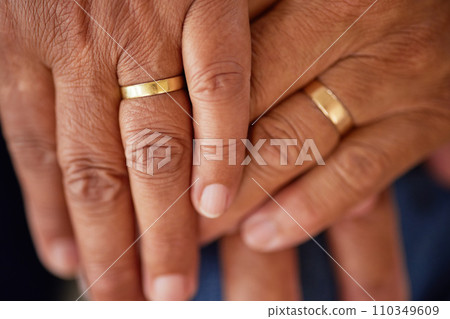 Support, trust and love of a senior married couple hands with rings and are in love for many years. Closeup of mature lovers touching and showing feelings of compassion and care Support, trust and love of a senior married couple hands with rings and are in love for many years. Closeup of mature lovers touching and showing feelings of compassion and care 110349609