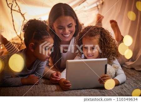 Home tent mother and kids on tablet watch movie or online children entertainment movies at night at house. Happy smile mom or woman and young girl youth family watching or playing fun internet games Home tent mother and kids on tablet watch movie or online children entertainment movies at night at house. Happy smile mom or woman and young girl youth family watching or playing fun internet games 110349634