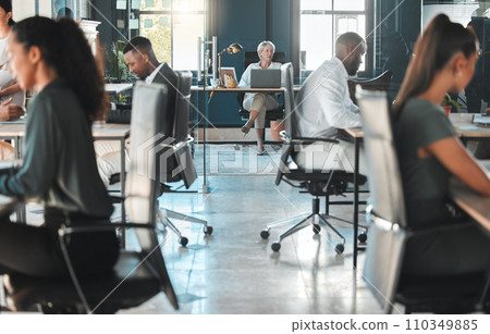 Corporate, modern office and diversity of business people working at their desk with the company CEO. Female leader working on her laptop. Busy staff working on projects in a professional workplace. 110349885