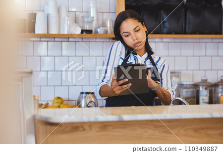 Cafe manager, planning online and working on digital tablet app with internet, phone call and sales in restaurant startup. Small business store, woman entrepreneur and coffee shop hospitality worker 110349887